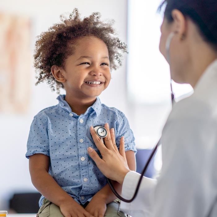 doctor treating young boy