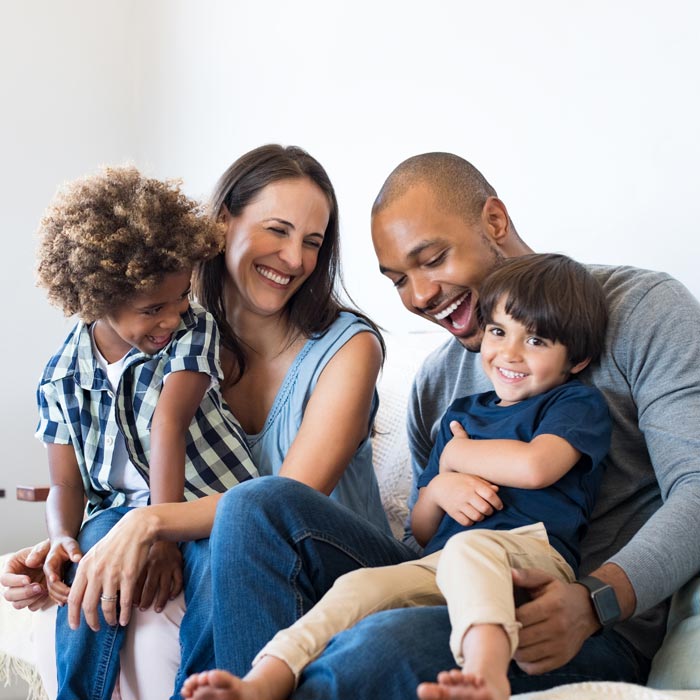 family of four smiling